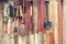 Agricultural tools hang on wooden wall in farm