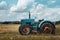 An agricultural tractor driving in the field