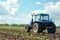 An agricultural tractor driving in the field