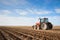 An agricultural tractor driving in the field