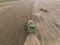 Agricultural tractor harvesting soybeans in the field