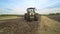 Agricultural tractor moving on field. Cultivation agricultural field