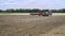 Agricultural tractor plowing field. Process plowing arable field. Plowed land