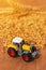 Agricultural tractor toy and harvested wheat