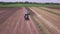 Agricultural tractor with trailer for plowing working on arable field