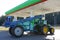 An agricultural tractor with a trailing device is fused at a fuel station