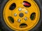 Agricultural tractor wheel with yellow disc on nuts