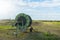 Agricultural water pipeline at farm with blue sky.