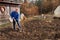 Agricultural work. Portrait of a man digging soil with shovel. Autumn yard work. A farmer preparing the ground for the winter.