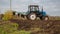 Agricultural work with tractors, plowing the land.