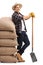 Agricultural worker leaning on pile of burlap sacks