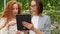 Agricultural Workers Checking Tomato Plants Using Digital Tablet. Beautiful young couple in casual clothes is holding a