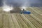 Agricultural works in the field. Combines, trucks and tractor