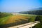 Agriculture in Croatia. A mown wheat field in a mountainous area between roads. Shooting from a drone