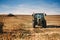 Agriculture details - Tractor and industrial machinery working the corn fields