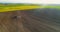 AGRICULTURE. Drone view of Agricultural tractor spraying field.