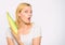 Agriculture and fall crops concept. Woman hold yellow corncob on white background. Corn crop harvest concept. Girl hold