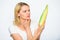 Agriculture and fall crops concept. Woman hold yellow corncob on white background. Girl hold ripe corn in hand. Food