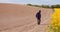 Agriculture - Farmer or Agronomist Walking on Field Looking at Crops.