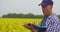 Agriculture farmer taking notes at rapeseed field