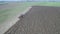 Agriculture and farming - Aerial view of tractor ploughing a field in early spring