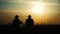 Agriculture farming two farmers men teamwork silhouette red neck in a field examining wheat crop at sunset. male farmers