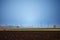 Agriculture field, electric posts, substation towers and industrial chimneys and factory