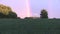 Agriculture field plants and rainbow in sky. Zoom out