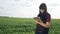 Agriculture. girl studying the crop eco smart farming with digital tablet. red lifestyle farmer neck worker working in a