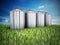 Agriculture grain silos on grass under blue sky. 3D illustration