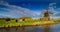 Agriculture idyllic landscape with cows and windmill. Historic water scoop mill and natural agriculture landscape by Wilstermarsch