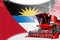 Agriculture innovation concept, red advanced rural combine harvester on Antigua and Barbuda flag - digital industrial 3D