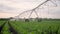 agriculture irrigation. irrigation a machinery wheels lifestyle irrigate green sprouts corn field water drops