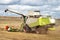 Agriculture machine works in field. Harvesting wheat. Combine harvester in field