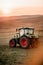 Agriculture machinery - Industrial tractor with trailer harvesting at dusk