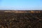 Agriculture plowed field. Dirt soil ground in farm. Tillage soil prepared for planting crop. Landscape of farmland