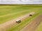 Agriculture roll lawn cultivating. Tractors on the field.