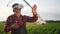 Agriculture virtual reality. A farmer in virtual reality glasses controls a machine to irrigate corn field. Agriculture