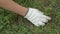 agriculture, weed control, a farmer in protective gloves tearing grass with his hands from the soil, overgrown land, a