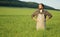 Agriculturist standing among green field