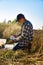 Agriculturist taking notes in soil sampling information sheet at field