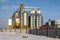 Agro silos granary elevator in winter day in snowy field. Silos on agro-processing manufacturing plant for processing drying