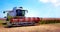 Agroindustrial industrial landscape with combine harvesters picking up hay on a rape field on a sunny day against a background of