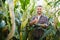 Agronomist checking corn if ready for harvest. Portrait of farmer