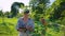 Agronomist examining young apple tree