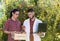 Agronomist and farmer in apple orchard