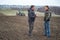 agronomist and farmer checks the soil moisture before sowing cereals