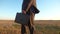 Agronomist, farmer goes on his land and examines the field against a blue sky. businessman in serious suit with