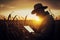 Agronomist farmer man using digital tablet computer in a young cornfield at sunset or sunrise