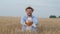 Agronomist grain grower, young man gives you delicious homemade bread smiling in grain harvest autumn meadow